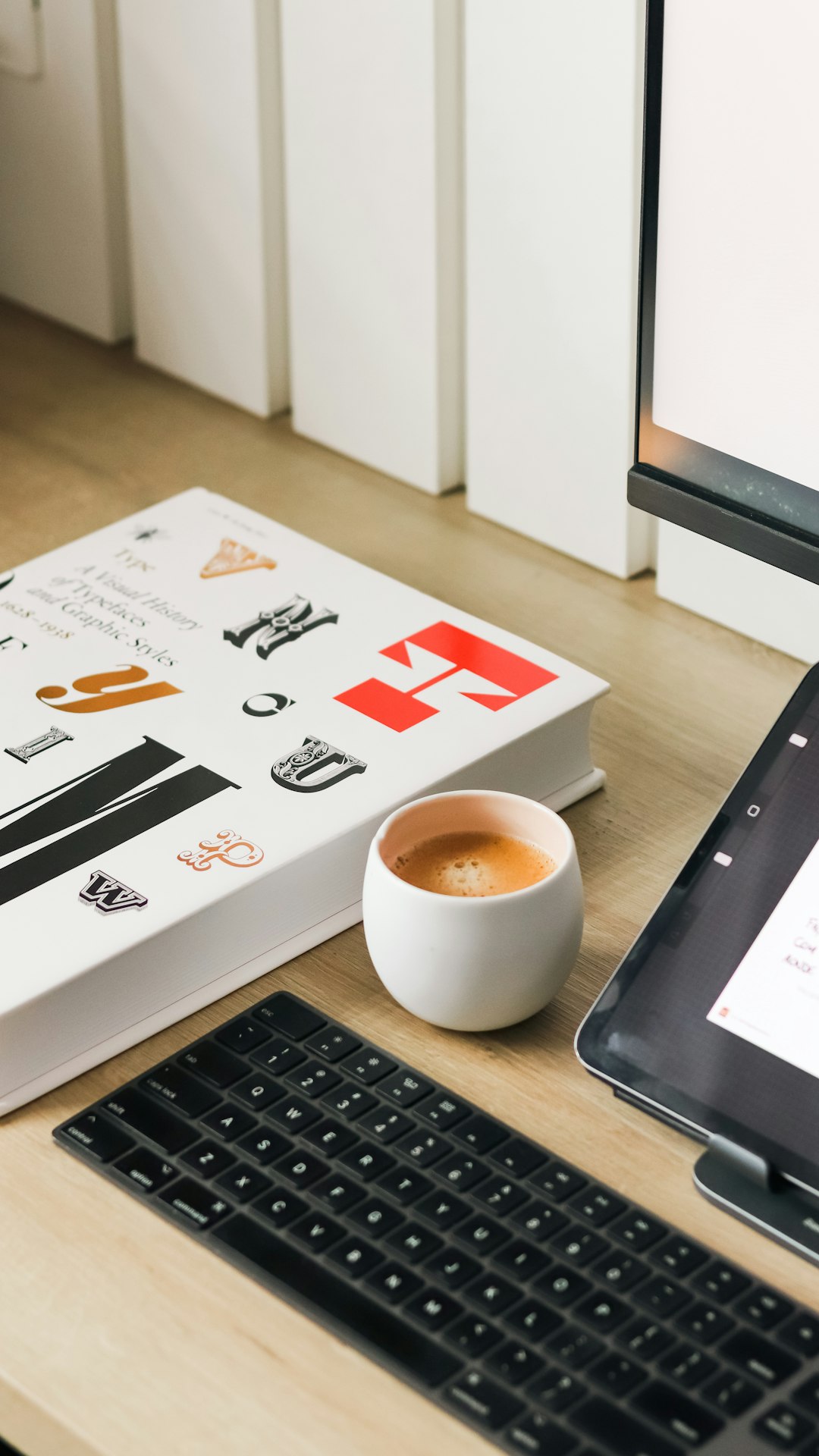 a-book-coffee-and-keyboard-on-a-desk-fkdcqcahqh4